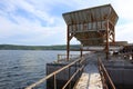 A huge steel hopper with a conveyor belt with gypsum debris and gravel on a pier for loading ships.