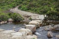 Huge stepping stones across a flowing stream near the Fairy Pools on the Isle of Skye