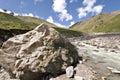 Huge stone near mountain river. Caucasus valley.