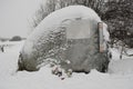 A huge stone with a thermometer under the snow