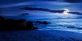 Huge stones on the sandy beach at night