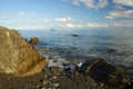 Huge stones, sea and waves. Seascape. A huge stone on the shore. Foamy waves rush onto the rocky shore. Royalty Free Stock Photo