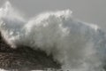 Stormy wave breaking over cliff