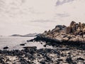 Huge strange stone and sea. Alien planet landscape, rock formations. Dramatic toned photo for unusual, mistick