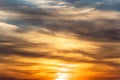 Huge sun behind stormy dramatic sky. background with yellow red and orange clouds. Sunset skyline. Storm on the beach. Royalty Free Stock Photo