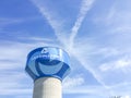 Water tower in Carrollton, Texas against cloud blue sky