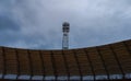 Huge tower over roof at stadium with huge lamps