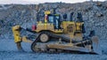 huge tracked bulldozer in the process of pushing material into open-pit mine waste dumps Royalty Free Stock Photo