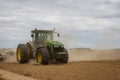 Huge tractor removes the field from the remains of vegetation. Spring . Ukraine, Sumy region