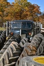 Huge tractor tires partially hie a truck