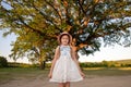 Huge Tree. a little girl by a big tree. child near with large green old oak Royalty Free Stock Photo