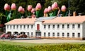 Huge tulips behind miniature house