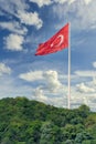 Huge Turkish flag at the mountains of Bosphorus strait, in a cloudy summer day, Istanbul, Turkey Royalty Free Stock Photo