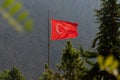 Huge Turkish flag waving between trees in Kemaliye or Egin, Erzincan, Turkey Royalty Free Stock Photo