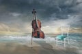 The huge violine in sea, waves  and sunset with chair, Wallpaper Royalty Free Stock Photo