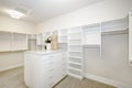 Huge walk-in closet with shelves, drawers and clothes rails