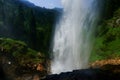 huge waterfall from a high cliff with view to the forest Royalty Free Stock Photo