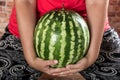 Huge watermelon in hand