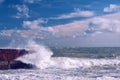 wave crashing on the pier on a sunny stormy day Royalty Free Stock Photo