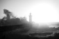 Huge wave at Lighthouse, Portugal. Black and white photo with grainy film effect. Royalty Free Stock Photo