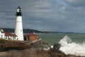 Huge Waves Break by Illuminated Portland Head Lighthouse in Main Royalty Free Stock Photo