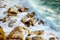 Waves breaking on a rocky beach over Porth Nanven in the Cot Valley of Cornwall, England Royalty Free Stock Photo