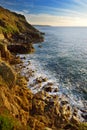 Waves breaking on a rocky beach over Porth Nanven in the Cot Valley of Cornwall, England Royalty Free Stock Photo