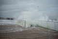 Huge waves cover the pier during a storm
