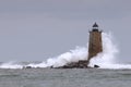 Huge Waves Crashing Around Stone Lighthouse Tower in Maine