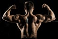 Huge weightlifter is standing with his back to the camera and st Royalty Free Stock Photo