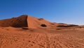 Huge well shaped sand dune with tracks seen from below in Erg Chebbi near Merzouga, Morocco, Africa.