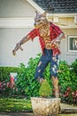 Huge Werewolf Halloween Decoration with rippled shirt and pants outside residential home with flower beds