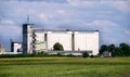 A huge white building for storing grain in the field Royalty Free Stock Photo