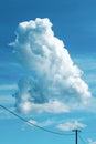 Huge white cloud at the sky, over the old wooden electricity post and wires Royalty Free Stock Photo