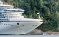 Huge white cruise liner passing by Stenley Park in Vancouver, Canada