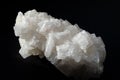 A huge white textured crystal of wild sea salt on a black background