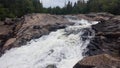 Huge white waterfall rushes down a rocky hillside Royalty Free Stock Photo