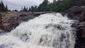 Huge white waterfall rushes down a rocky hillside Royalty Free Stock Photo