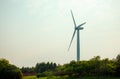 A huge wind turbine at sunset standing above the skyline in Chongming Island, Shanghai