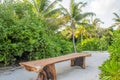 Huge wooden table surrounded by bushes and trees at the tropical beach