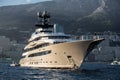 The huge yacht is beige color in sea at sunset, glossy board of the motor boat, the chrome plated handrail, megayacht is