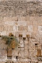 Huge yellow ancient stones of the Wall of Tears with notes between