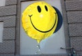 Large yellow smiley face street art on side of old building, Downtown Worcester MA, spring, 2020