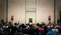 A huged of visitors take photo of Mona-Lisa in Louvre museum