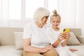 Hugging granddaughter family phone togetherness bonding grandmother smiling sofa child selfie Royalty Free Stock Photo