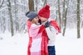 Girl and boy make warm each other in winter forest Royalty Free Stock Photo