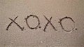 Hugs And Kisses XOXO Sign On Beach Sand