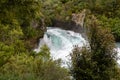Huka falls in New Zealand behind native trees Royalty Free Stock Photo