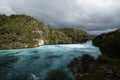 Huka Falls on Waikato River, New Zealand. In cloudy day Royalty Free Stock Photo