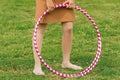 Hula hoop massage hoop for weight loss on the background of grass in the open air, close-up. outdoor Royalty Free Stock Photo
